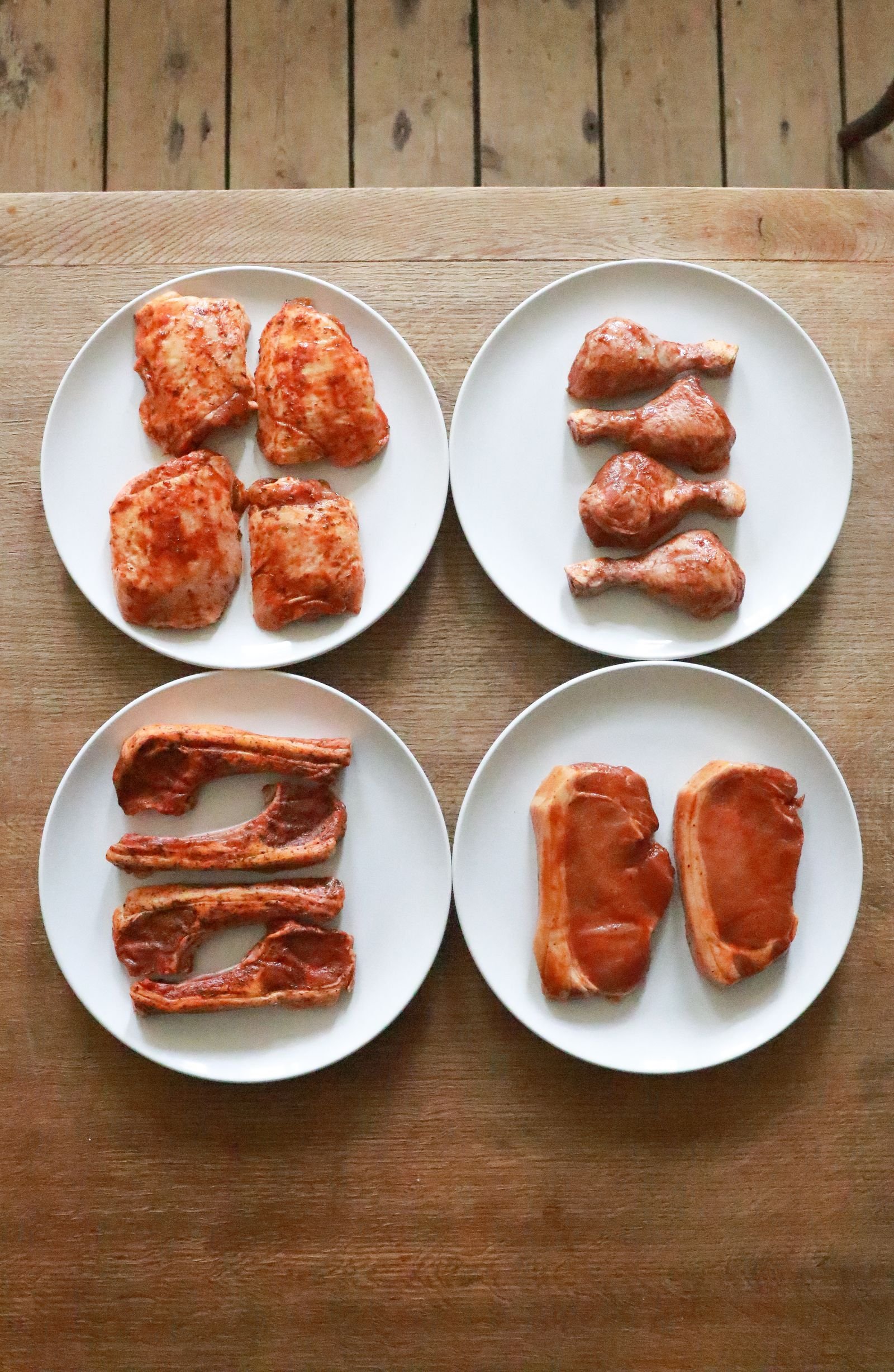 Frozen chicken, beef and pork cuts on ice